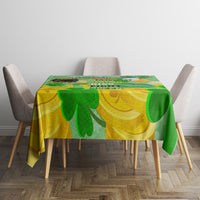 Green and gold shamrock tablecloth on dining table, clover design across surface