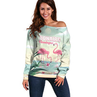Off-shoulder mint sweater with flamingo graphic and 'BONAIRE Flamingos' text, long sleeves