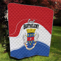 Red and white quilted blanket with Saint Barthelemy crest over blue lower section