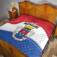 Red, white, and blue quilt on a bed featuring Saint Barthelemy coat of arms emblem