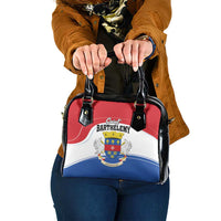 Shoulder handbag with red, white, and blue coat-of-arms print and black leather handles