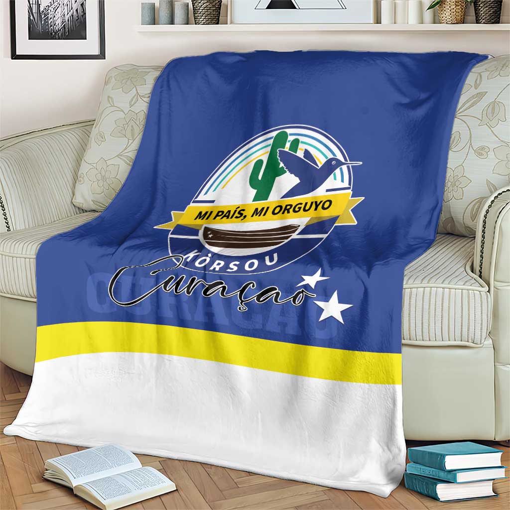 Blue blanket with Curaçao crest, yellow stripe, and white lower section