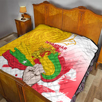 Myanmar flag quilt on a bed, quilted texture with yellow, red, green, and white panel colors