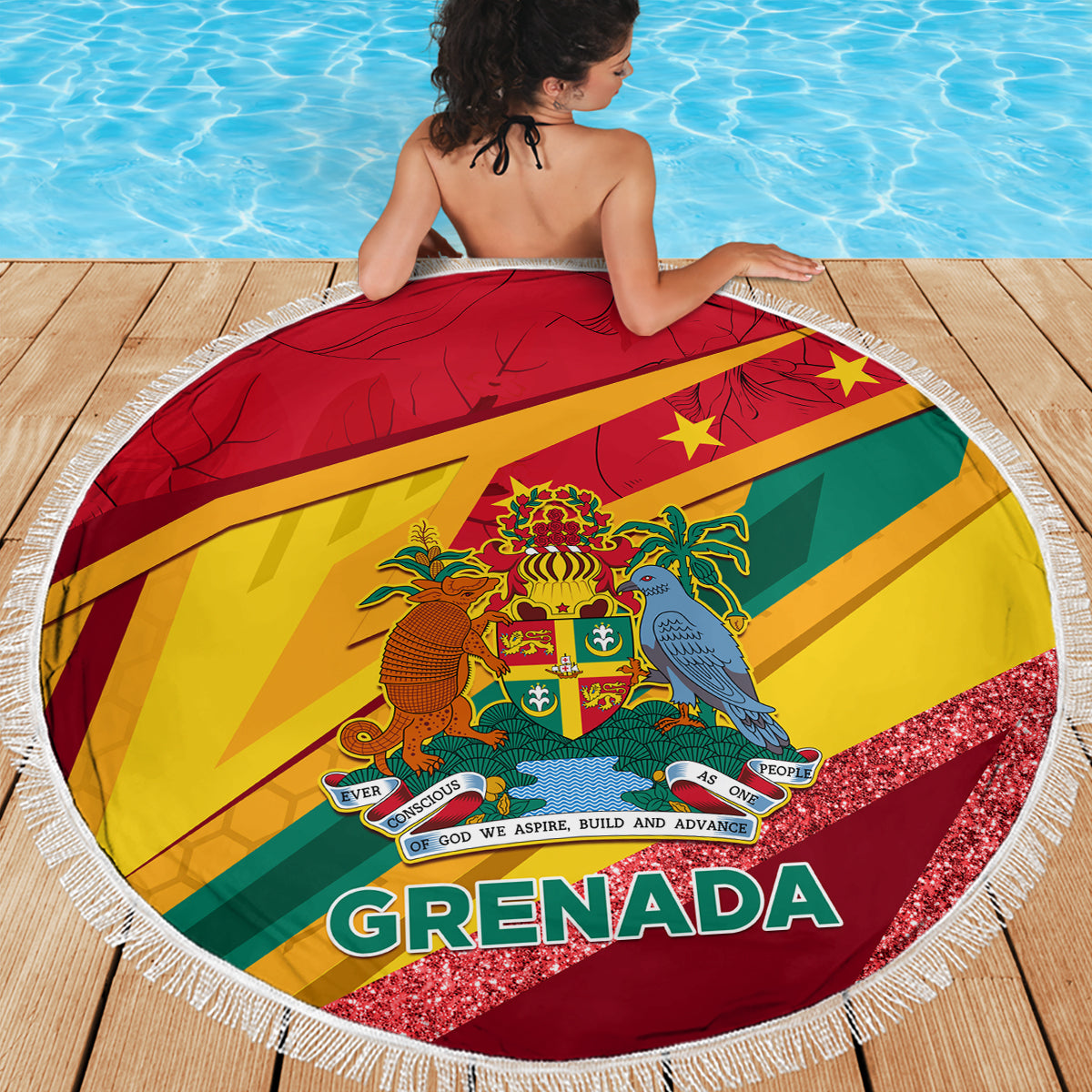 Round Grenada flag beach blanket with white fringe, laid on a wooden deck