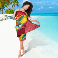 Independence Day sarong with Grenada flag print and glittery red panel, worn to side