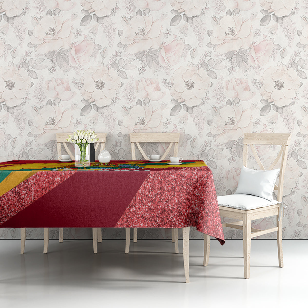 Red glitter-speckled tablecloth with Grenada-themed multicolor trim on tabletop
