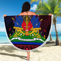 Fringed round beach blanket with bold Haitian HAITI graphic, central emblem and guns illustration