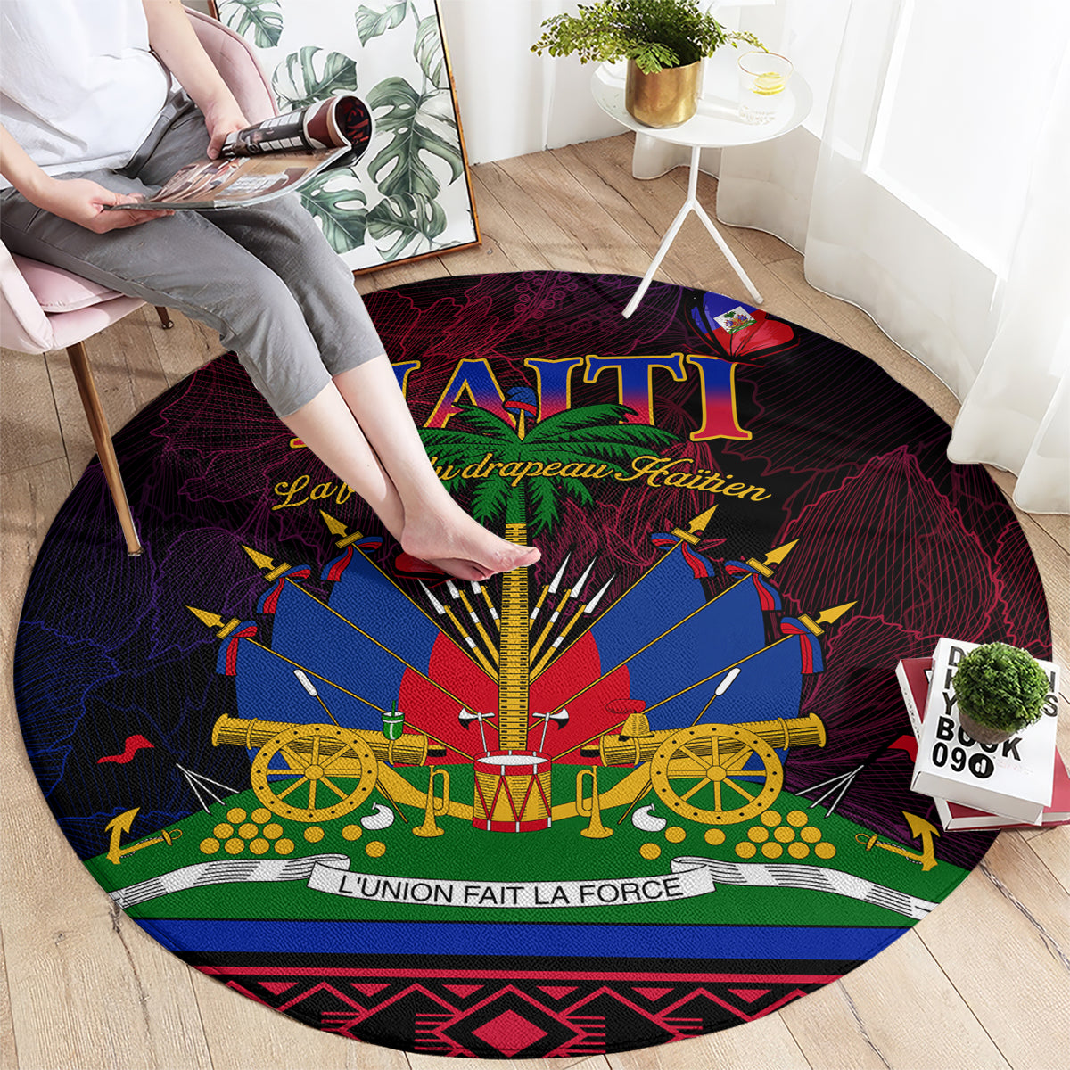 Round Haitian flag carpet with cannon design; viewed from top with hands on it