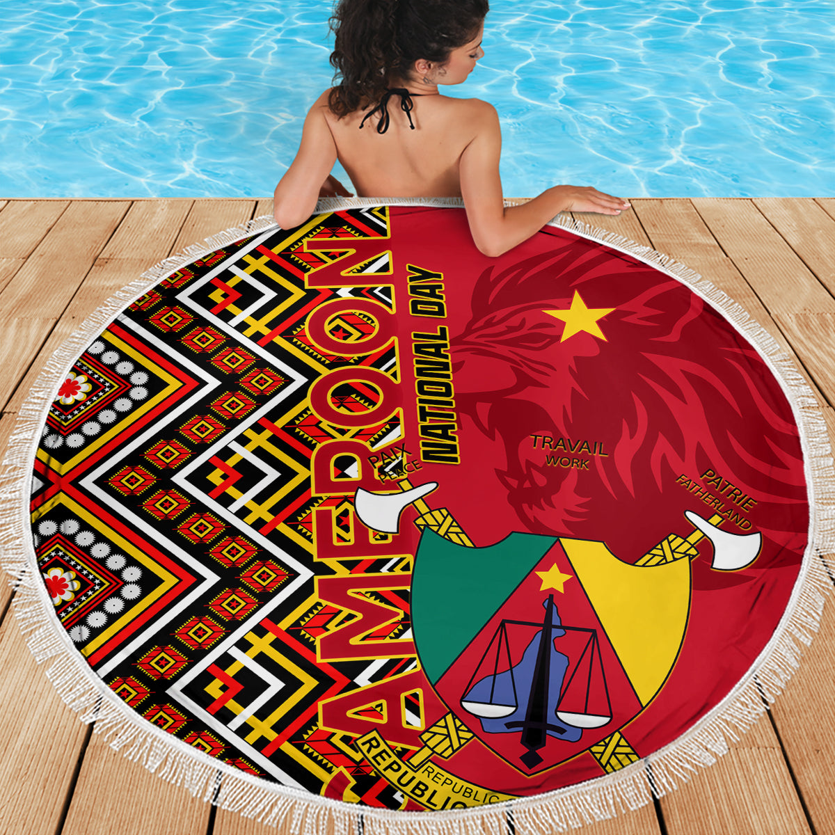 Round fringed beach blanket with Cameroon coat-of-arms, red and geometric Ankara blocks