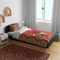Cameroon national day bedding set on bed with geometric red, black, and white duvet and matching pillows