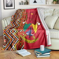 Cameroon national day blanket on bed, red and multicolor Ankara pattern with coat of arms