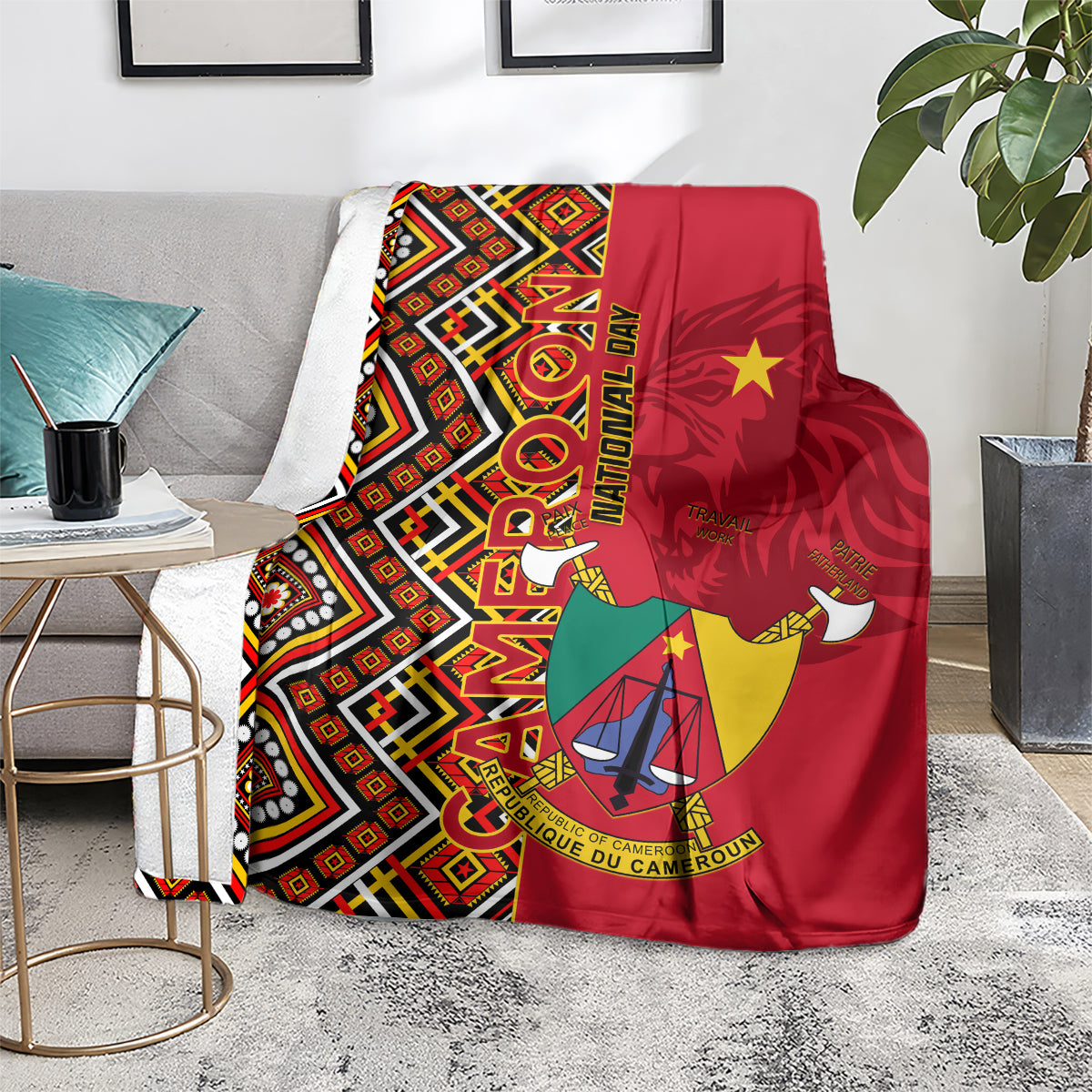 Cameroon national day blanket draped on sofa, red geometric Ankara pattern with coat of arms