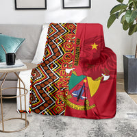 Cameroon national day blanket draped on sofa, red geometric Ankara pattern with coat of arms