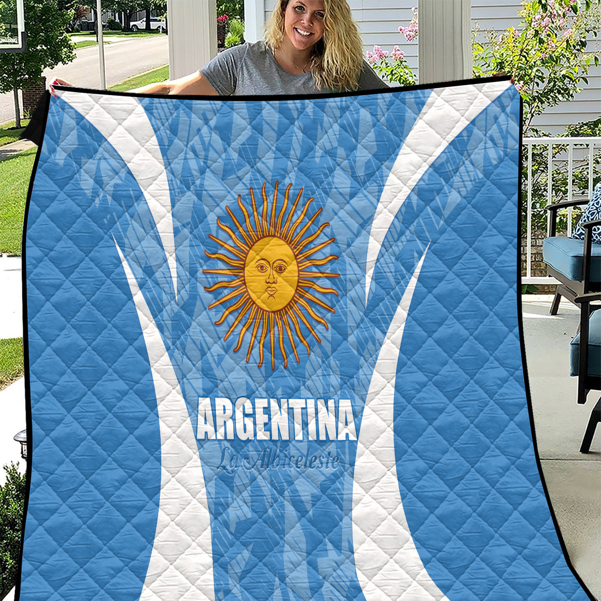 Argentina blue quilt blanket with white diagonal stripes and sun emblem, quilted texture