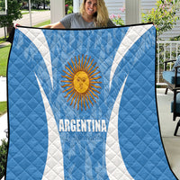 Argentina blue quilt blanket with white diagonal stripes and sun emblem, quilted texture
