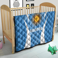 Argentina blue quilt blanket with sun emblem and white diagonal stripes on a crib