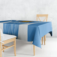 Blue Argentina-themed tablecloth with diagonal texture, draped over a rectangular dining table.