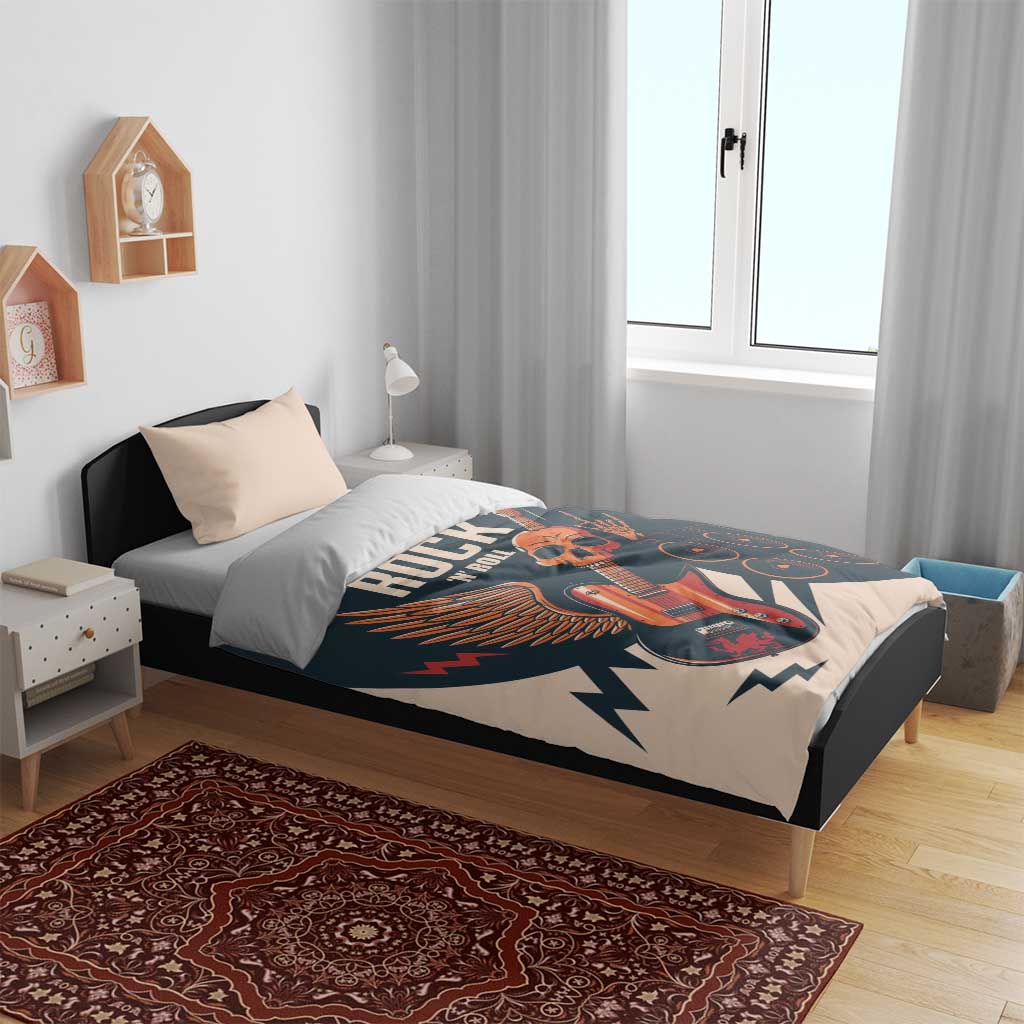 Rock-themed bedding set on bed with skull guitar print across beige and dark teal duvet