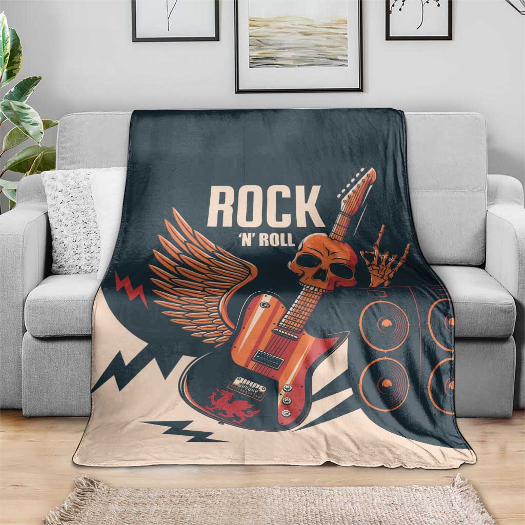 Rock skull guitar blanket draped on sofa, dark teal and beige with guitar and amp print