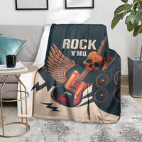 Rock skull guitar blanket on sofa, dark teal and beige with winged guitar and skull artwork
