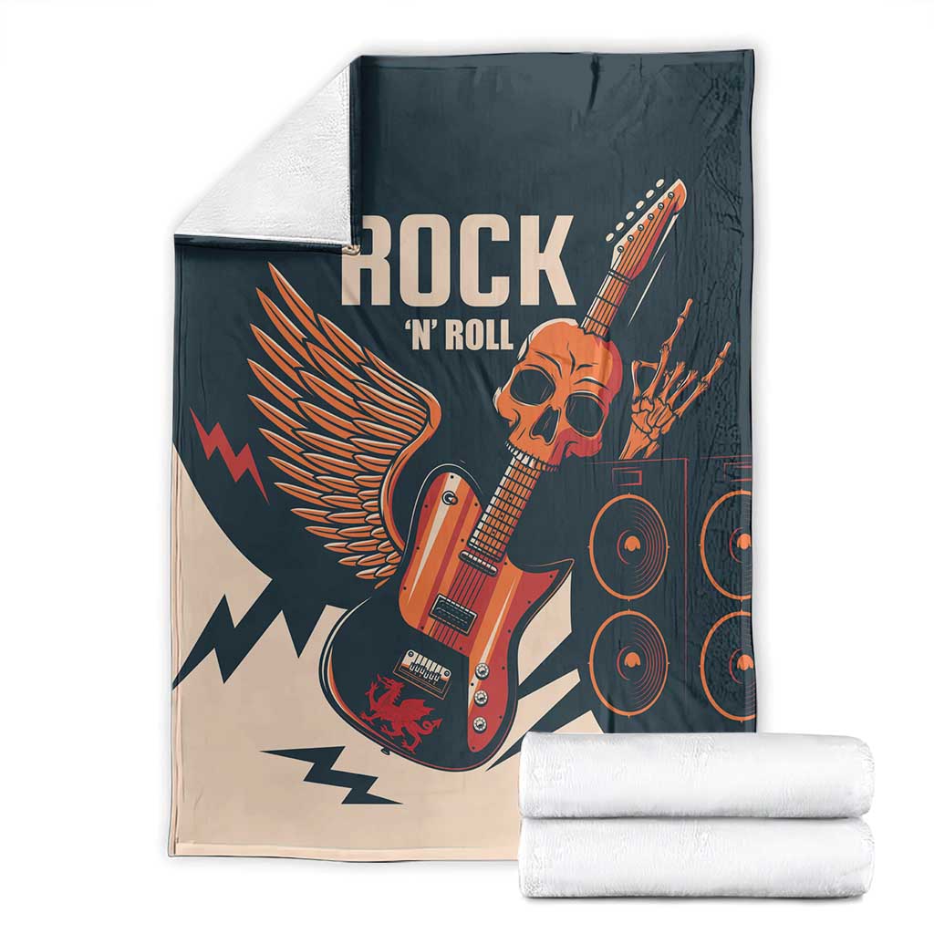 Rock skull guitar blanket with stacked towels, dark teal and beige with winged guitar print