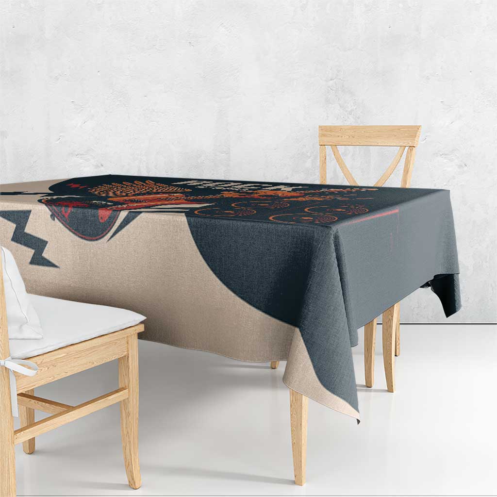 Skull guitar tablecloth draped over table edge, dark teal and beige print
