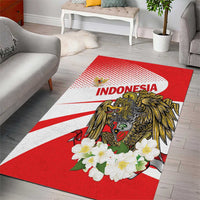 Red area rug with white rays, gold eagle and floral design, 'INDONESIA' text