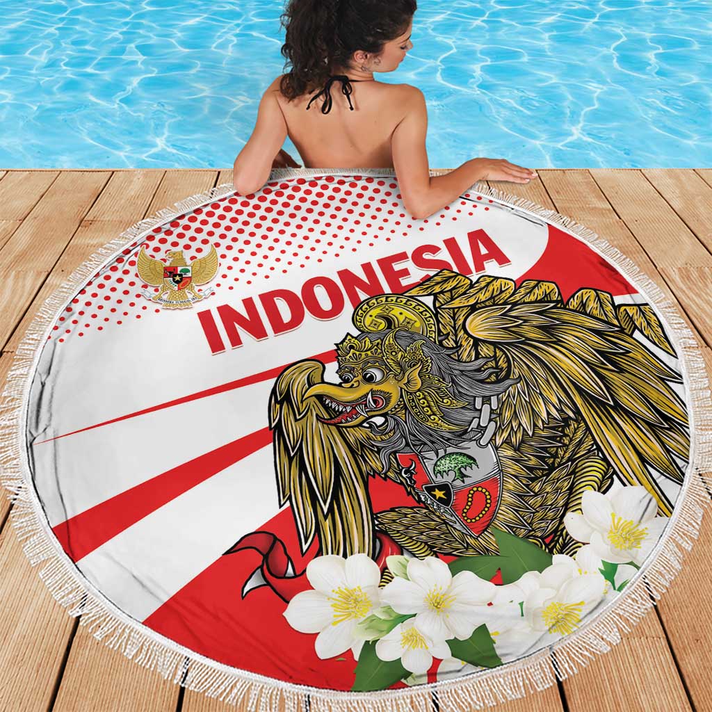 Round beach blanket with fringe showing Indonesia lion-and-eagle graphic and white flowers