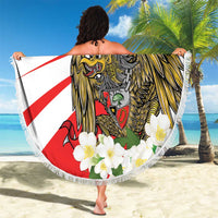 Round beach blanket with fringe held up, Indonesia lion-and-eagle print and red stripe