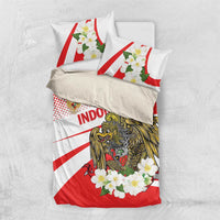 Red and white bedding set viewed from above with eagle emblem, flower wreath, and “Indonesia” text