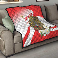 Red and white quilt blanket with Indonesia text, eagle illustration, and flower detail