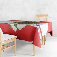 Red tablecloth corner detail with white stripes and white blossom accents