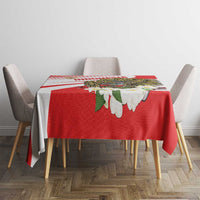 Red tablecloth with white diagonal stripes and large hawk eagle floral print
