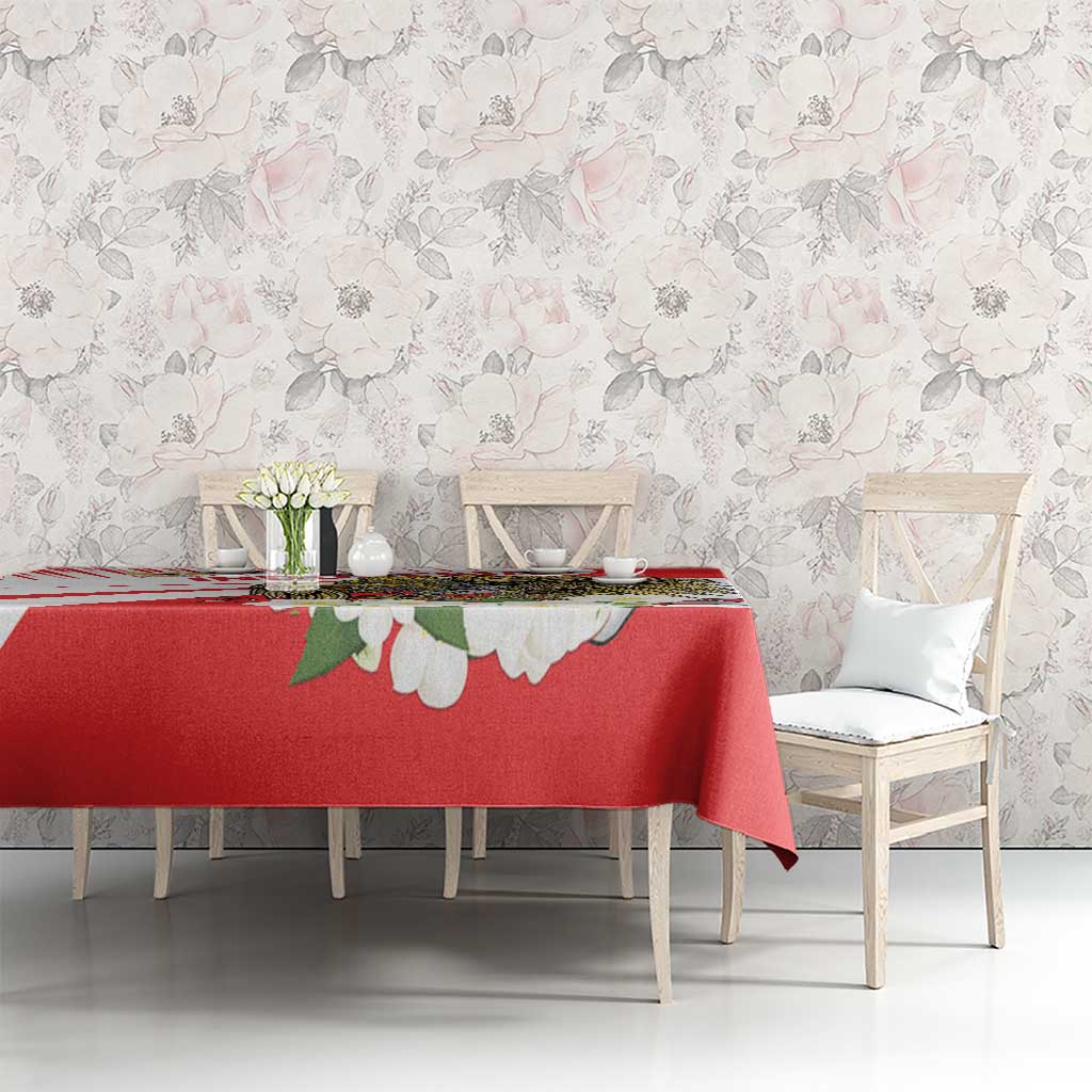 Red tablecloth with hawk eagle and jasmine-style white flower motifs