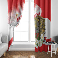 Red and white curtain panels framing a window with gold eagle and floral print