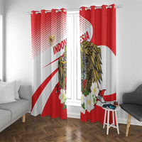 Two red and white curtains on a rod with gold eagle design and floral border