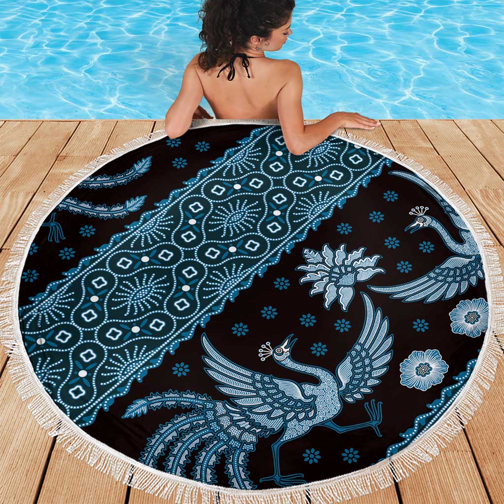 Blue batik-pattern beach blanket with white fringe trim, peacock and floral details.