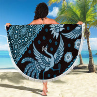 Blue batik-pattern beach blanket with white fringe edge, round bird and blossom design.