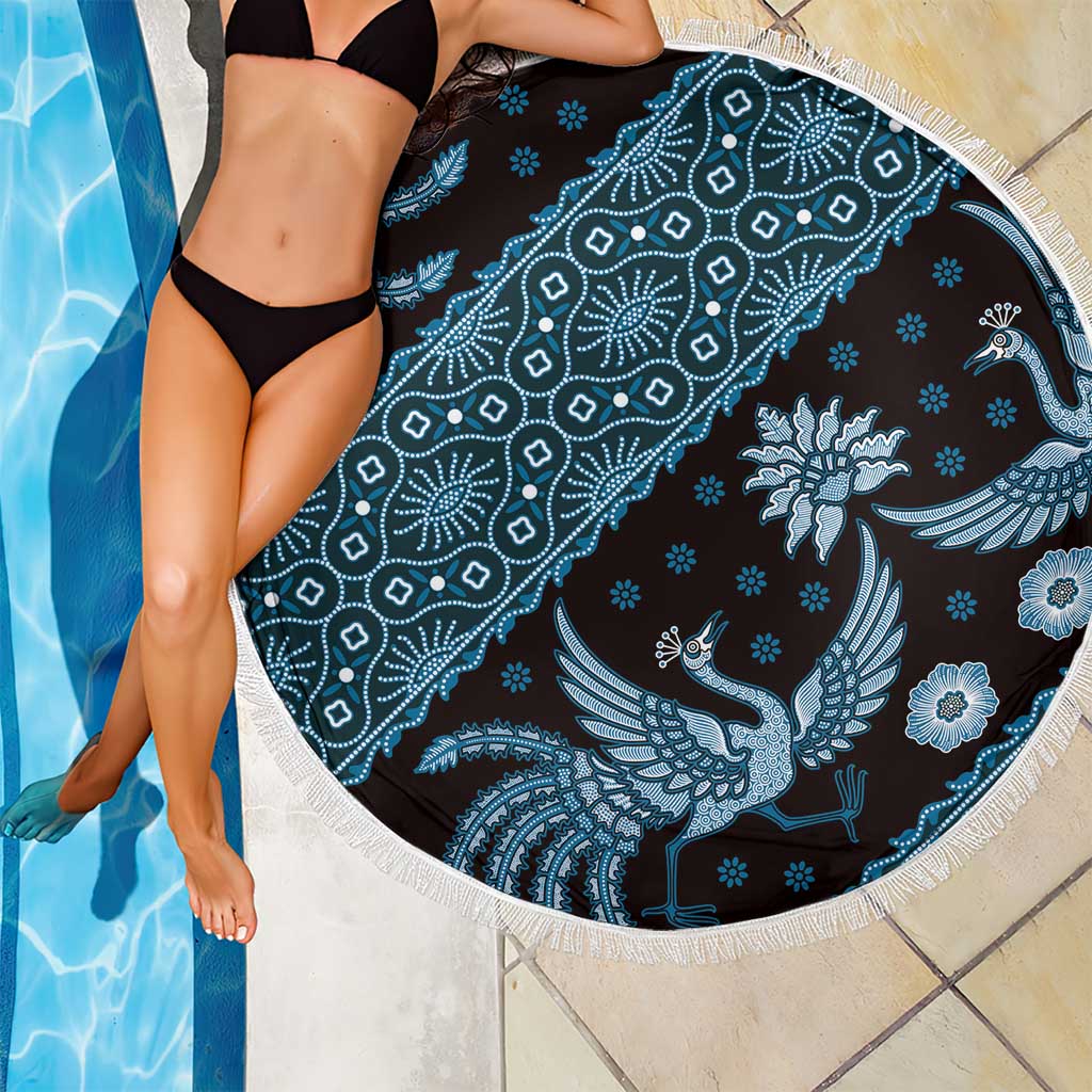 Blue batik-pattern beach blanket with white fringe border, peacock and flower motifs.