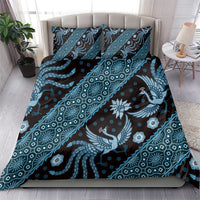Blue batik-pattern bedding set with duvet and two pillowcases on bed
