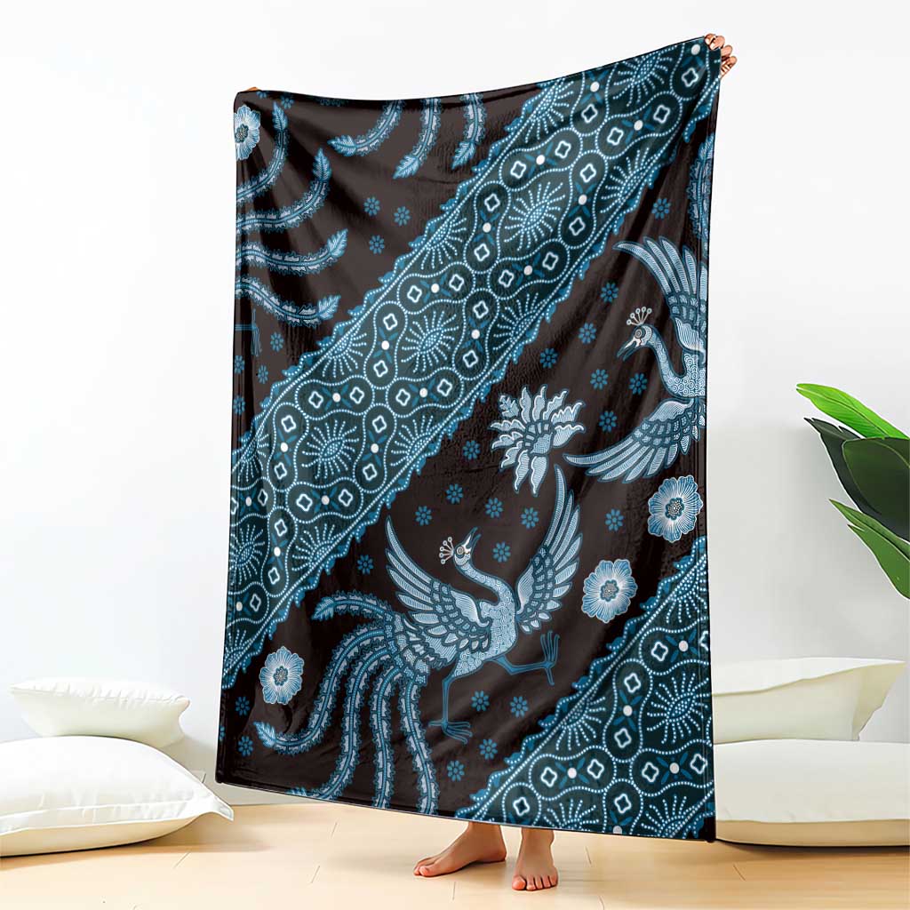 Blue batik-pattern blanket hanging, repeating bird and floral motifs in patterned bands
