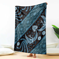 Blue batik-pattern blanket hanging, repeating bird and floral motifs in patterned bands
