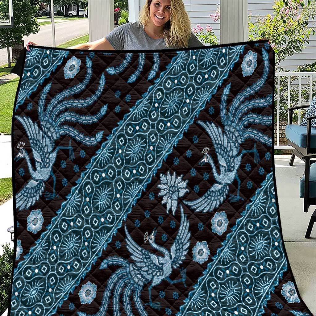 Blue batik pattern quilt with ornate dragon and floral motif, dark backing