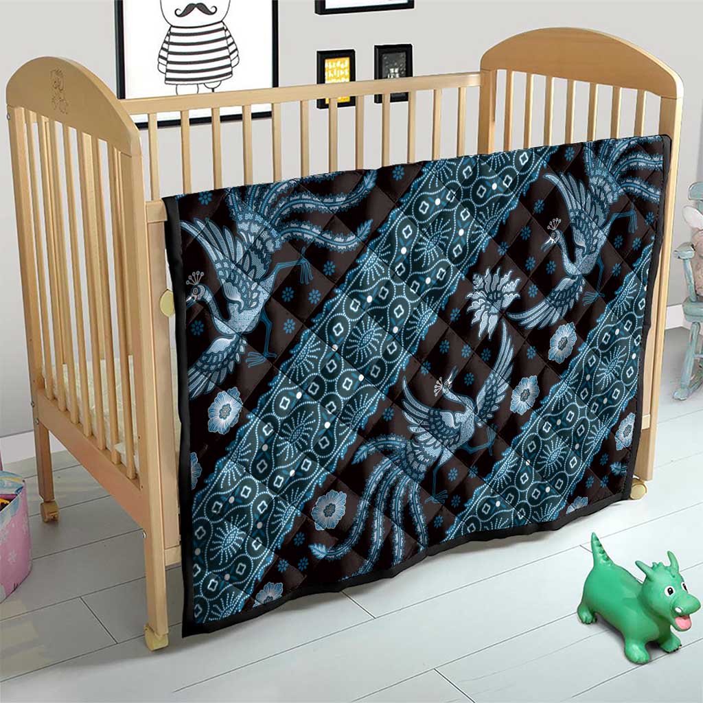 Blue batik pattern quilt on a wooden baby crib, dragon and floral medallion print