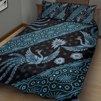 Blue batik-pattern quilt and pillow set with bird, floral, and geometric motifs