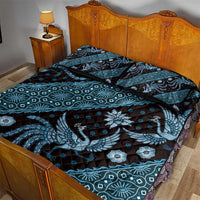 Blue batik-pattern quilt bed set with bird and floral motifs on duvet and pillows
