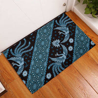 Blue batik pattern rubber doormat with bird and floral motifs, corner view