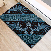 Blue batik pattern rubber doormat with bird and geometric motifs, angled corner view