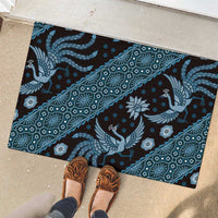Blue batik pattern rubber doormat featuring peacock and medallion motifs, wide view