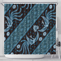 Blue patterned shower curtain with repeating birds, flowers, and swirling batik lines